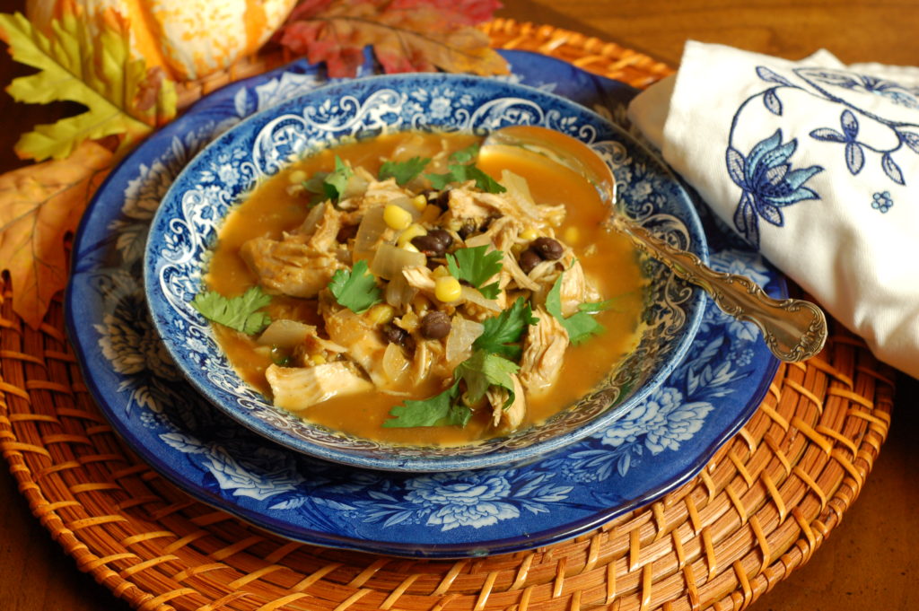 Southwest Chicken Pumpkin Soup, black beans, corn kernels, chipotle peppers, cumin, green chiles soup in a bowl